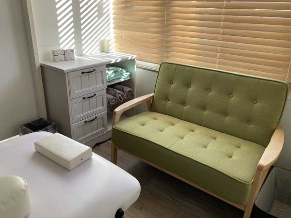 chest of drawers and sofa in treatment room